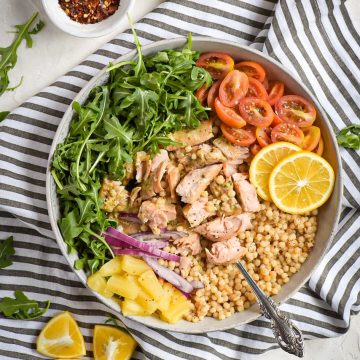 baked roasted garlic and butter salmon with couscous tropical bowl