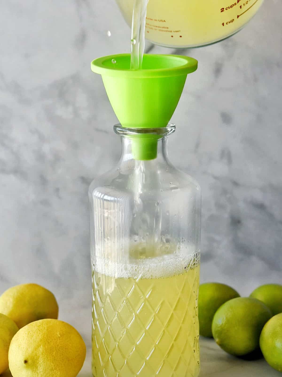 sweet-and-sour-mix-pour-using-a-funnel-into-glass-jar